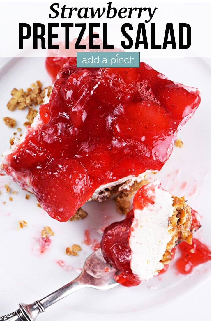 Strawberry Pretzel Salad on plate with fork - with text - addapinch.com
