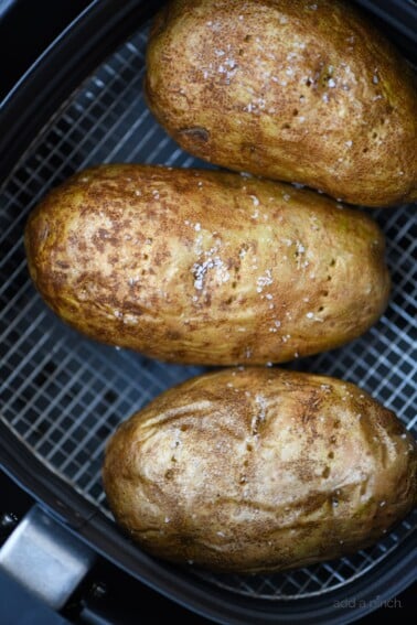 Air Fryer Baked Potato Recipe - This quick and easy air fryer baked potato recipe makes a perfect baked potato every time! Tender on the inside and crispy on the outside! // addapinch.com
