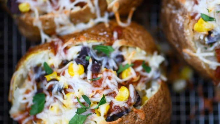 Air Fryer Enchilada Stuffed Baked Potatoes Recipe - This quick and easy recipe combines a perfect baked potato filled with black beans, enchilada sauce, and more! // addapinch.com