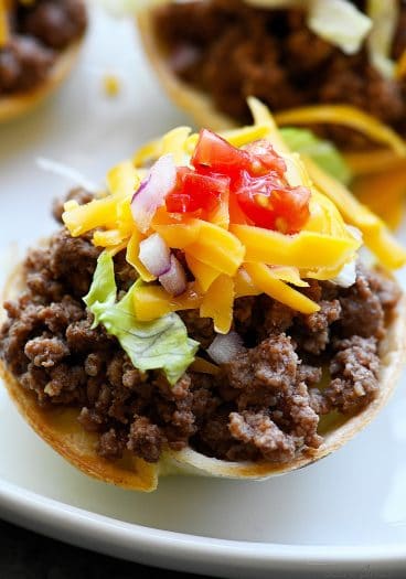 Taco Cups Recipe - This Taco Cups Recipe comes together in 15 minutes for a fast, fun, and fabulous dish! Made with just five ingredients, plus optional toppings, it is sure to be a weeknight staple! // addapinch.com