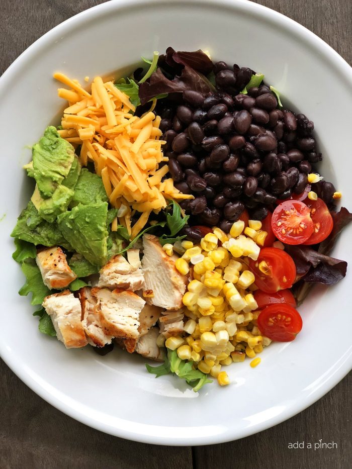 BBQ Ranch Chicken Cobb Salad Recipe - Filled with grilled chicken, corn, black beans, avocado, bacon and more, this flavorful chicken cobb salad recipe is perfect for lunch or supper!  // addapinch.com