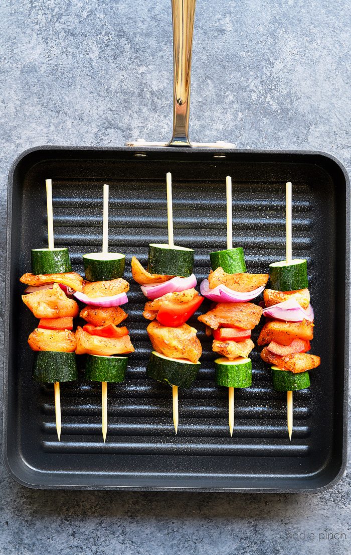 Chili Rubbed Chicken Skewers Recipe - Ready in minutes, these chicken skewers are a weekend AND a weeknight favorite! The secret is the chili rubbed chicken! // addapinch.com