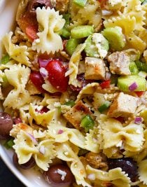 Greek Chicken Pasta Salad Recipe - This easy pasta salad recipe is so easy and delicious! Made with grilled chicken, pasta, an assortment of vegetables and topped with feta cheese and a delicious Greek dressing! // addapinch.com