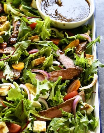 Balsamic Steak Salad Recipe - A hearty balsamic steak salad recipe is served with lots fresh vegetables, mozzarella, fresh basil and a Homemade Balsamic Vinaigrette. // addapinch.com