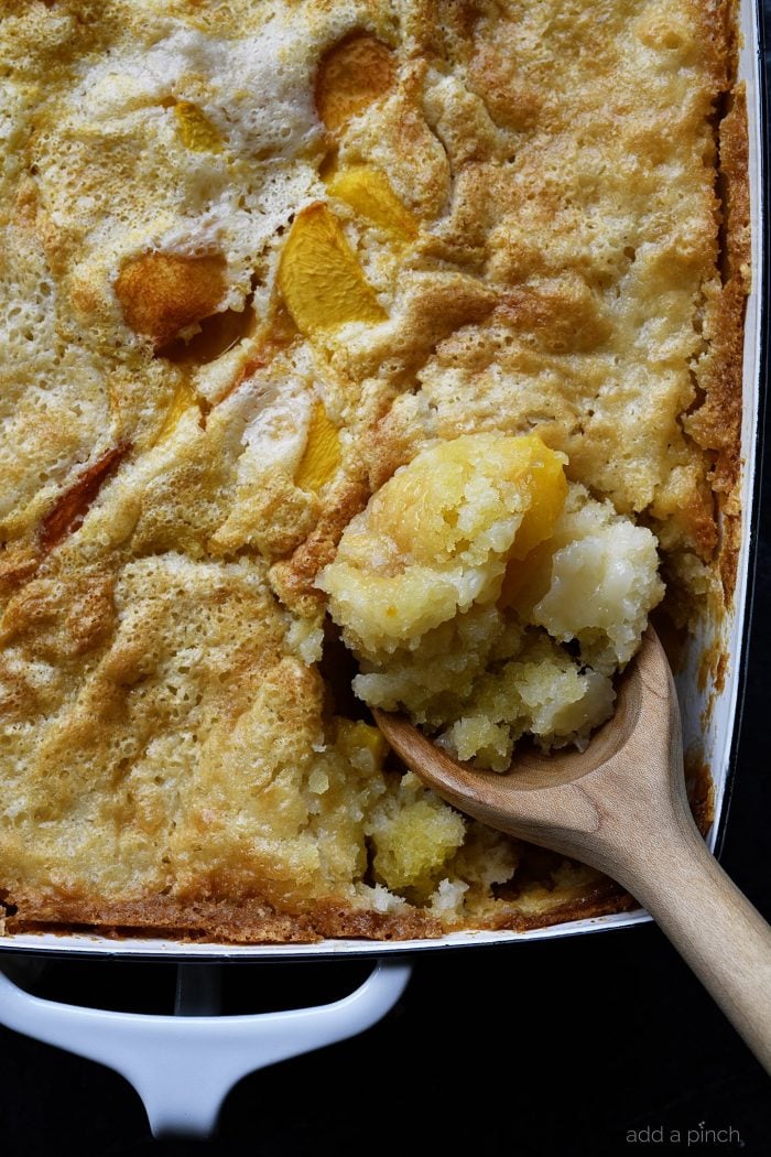 Easy Peach Cobbler Recipe - This easy peach cobbler makes the perfect Southern dessert! A buttery crust bakes along with the sweet peaches for the best peach cobbler in three easy steps! // addapinch.com