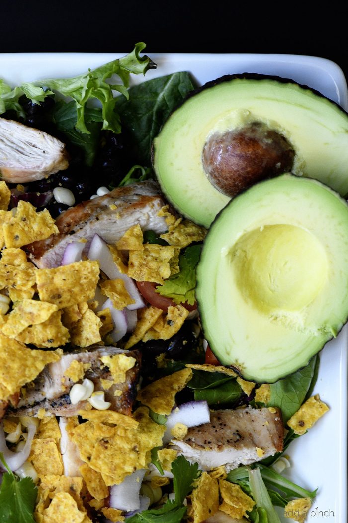Grilled Chicken Fiesta Salad Recipe - This simple grilled chicken salad recipe is kicked up a notch for a spicy Tex-Mex favorite! // addapinch.com