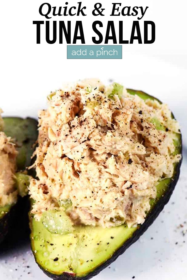 Scoop of Tuna Salad inside avocado halves - with text - addapinch.com