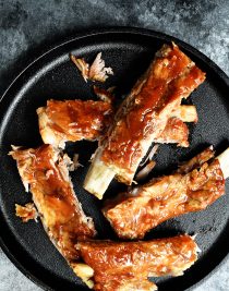 Easy Slow Cooker Ribs Recipe - This easy slow cooker ribs recipe makes tender, fall off the bone ribs! No grill or oven is required with these amazing ribs! // addapinch.com