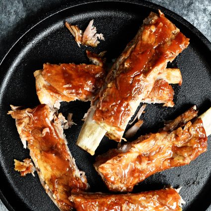Easy Slow Cooker Ribs Recipe - This easy slow cooker ribs recipe makes tender, fall off the bone ribs! No grill or oven is required with these amazing ribs! // addapinch.com