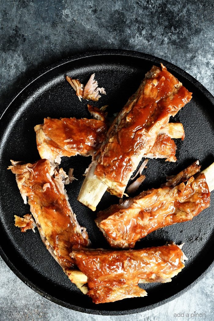 Easy Slow Cooker Ribs Recipe - This easy slow cooker ribs recipe makes tender, fall off the bone ribs! No grill or oven is required with these amazing ribs! // addapinch.com
