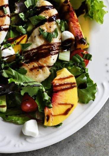 Grilled Chicken and Peach Salad Recipe - A light and delicious dish  that is perfect for lunch or dinner. Made with grilled chicken, fresh juicy peaches, and topped with tangy balsamic. // addapinch.com