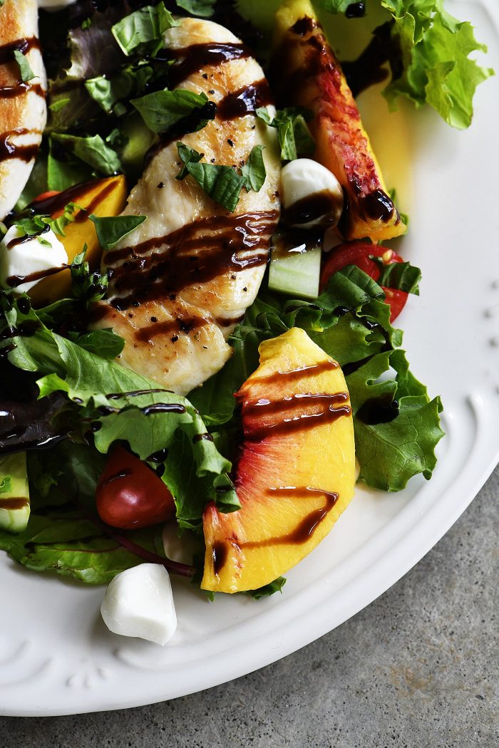 Grilled Chicken and Peach Salad Recipe - A light and delicious dish  that is perfect for lunch or dinner. Made with grilled chicken, fresh juicy peaches, and topped with tangy balsamic. // addapinch.com