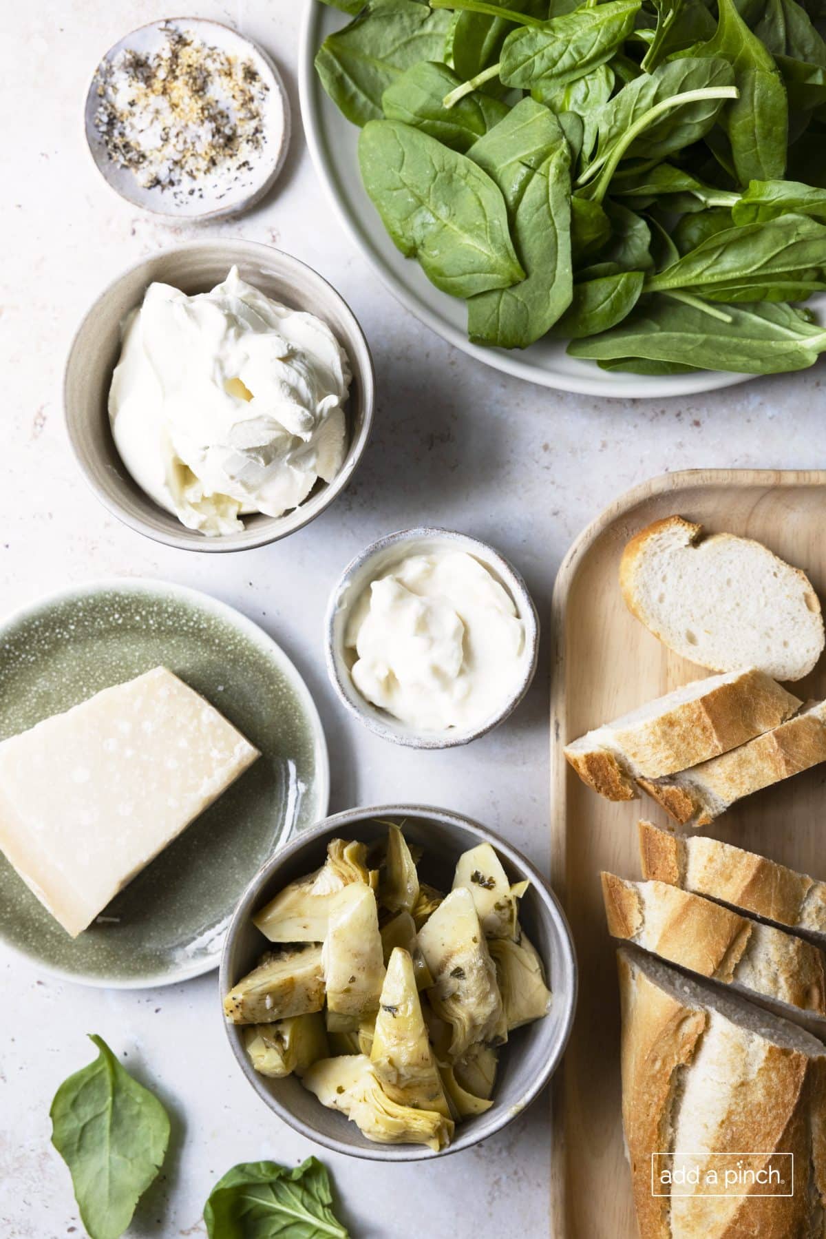 Photograph of ingredients needed to make and serve spinach artichoke dip recipe.