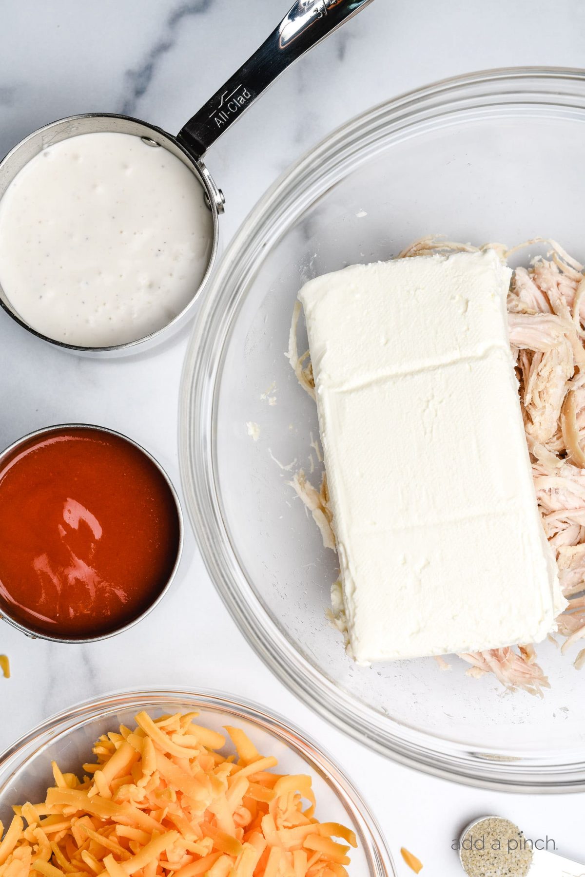 Buffalo Chicken Dip tastes like the buffalo chicken wings we love but without the mess! This easy appetizer is made with just a handful of ingredients in the oven or slow cooker! // addapinch.com