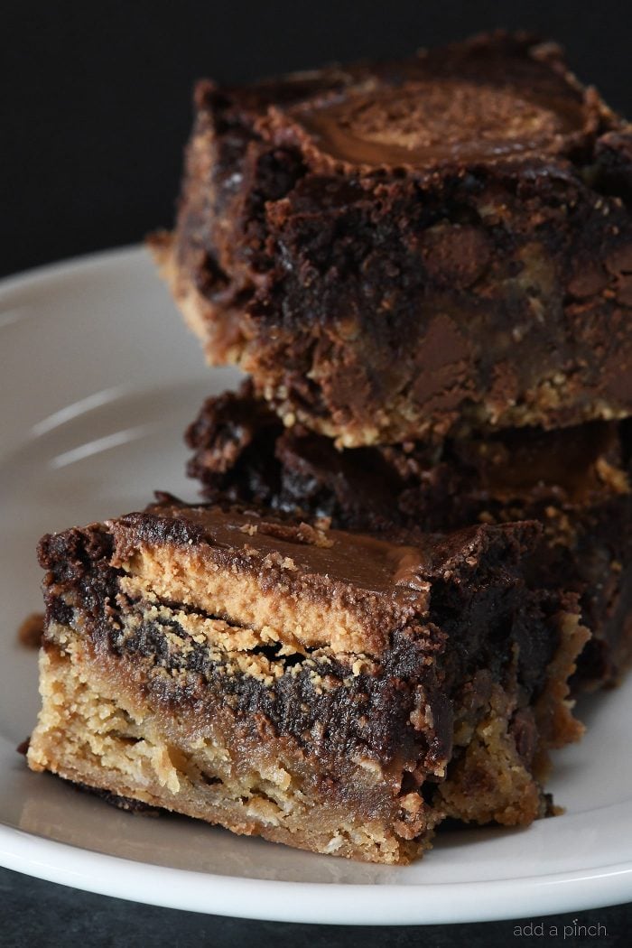 Peanut Butter Cup Brookies Recipe - This recipe takes brownies to a whole new level! Layers of chocolate chip cookie, fudgy brownies, and peanut butter cups make a dessert that everyone loves! // addapinch.com