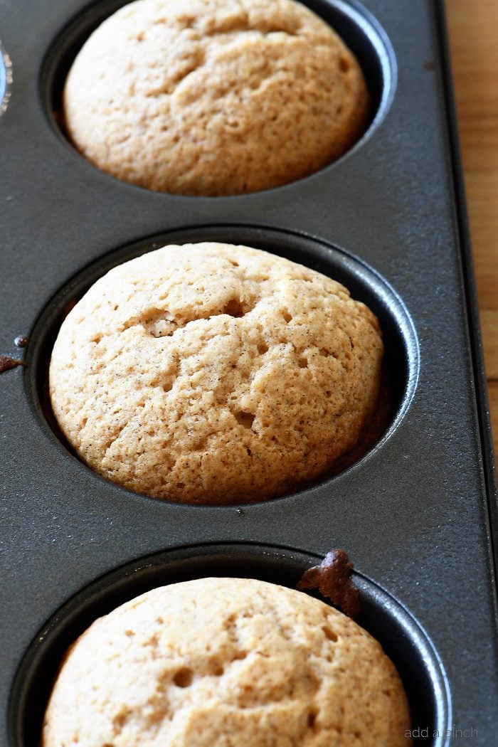 Apple Cider Donut Muffins Recipe - These apple cider muffins are light, fluffy and coated in an amazing cinnamon sugar coating! // addapinch.com