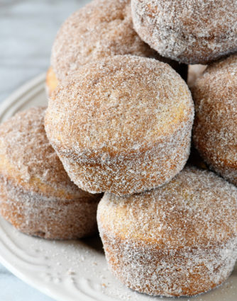 Apple Cider Donut Muffins Recipe - These apple cider muffins are light, fluffy and coated in an amazing cinnamon sugar coating! // addapinch.com