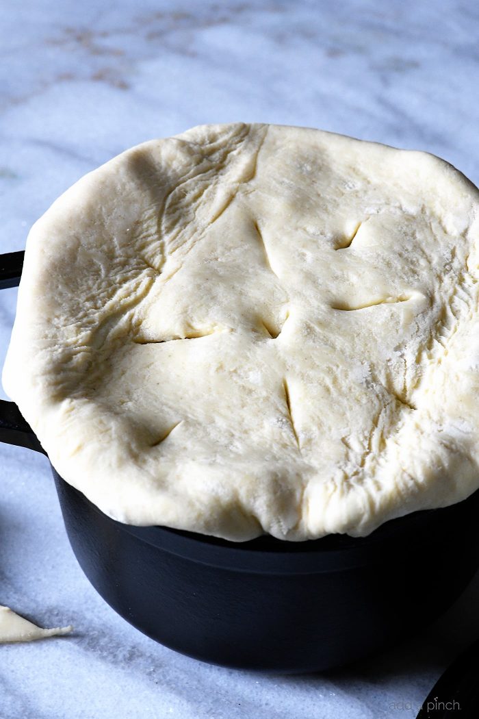 Puff Pastry is laid across top of black dutch oven. On marble countertop  // addapinch.com