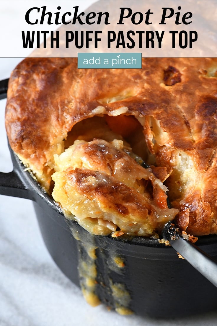 Cast iron pot with Chicken Pot Pie with Puff Pastry being spooned out - with text - addapinch.com