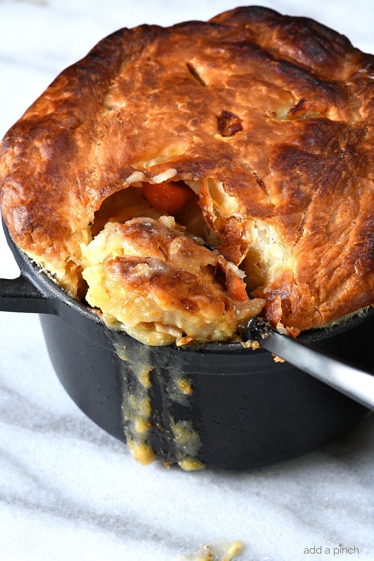Chicken pot pie with puff pastry with a spoonful ready to enjoy.