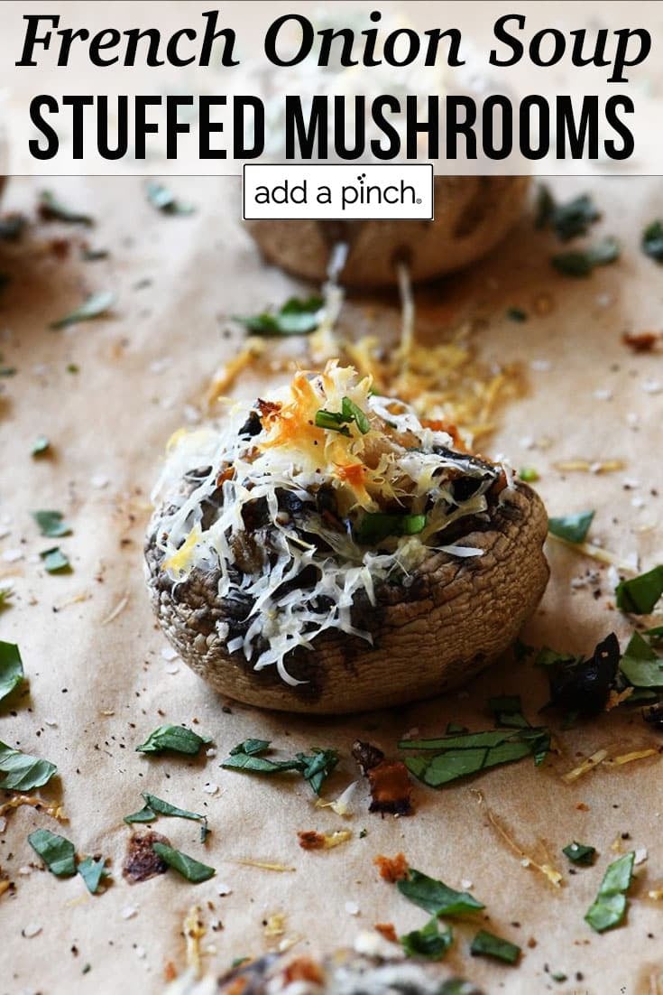 Baking dish with cooked French Onion Soup Stuffed Mushrooms - with text - addapinch.com