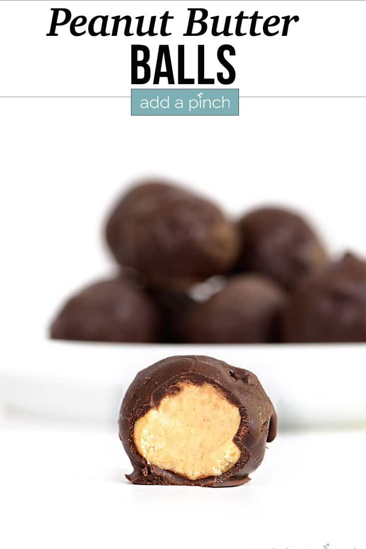 Peanut Butter Balls stacked with one with bite take from it - with text - addapinch.com