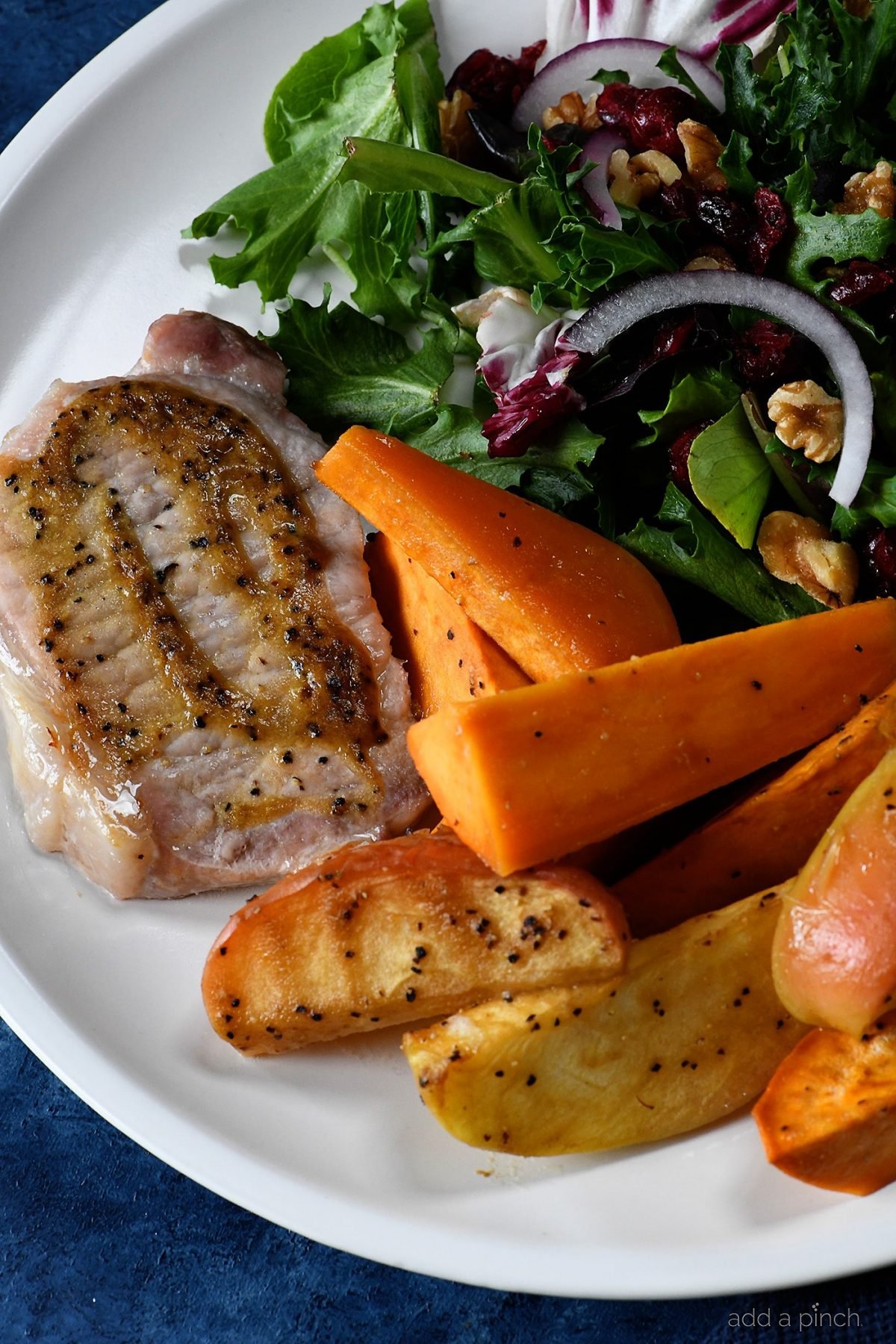 Sheet Pan Pork Chops with Sweet Potatoes and Apples Recipe - This easy one pan meal comes together in a snap! Pork chops, sweet potatoes and apples all basted in a balsamic dijon sauce and baked to perfection!