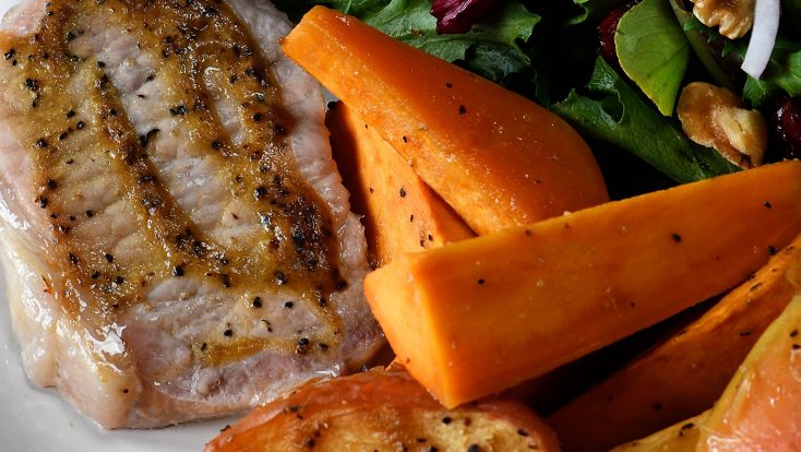 Sheet Pan Pork Chops with Sweet Potatoes and Apples Recipe - This easy one pan meal comes together in a snap! Pork chops, sweet potatoes and apples all basted in a balsamic dijon sauce and baked to perfection! // addapinch.com