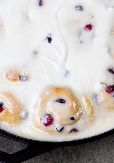 Cranberry Orange Rolls Recipe - The perfect blend of sweet and tart comes together in these easy Cranberry Orange Rolls! Topped with Orange Cream Frosting! // addapinch.com