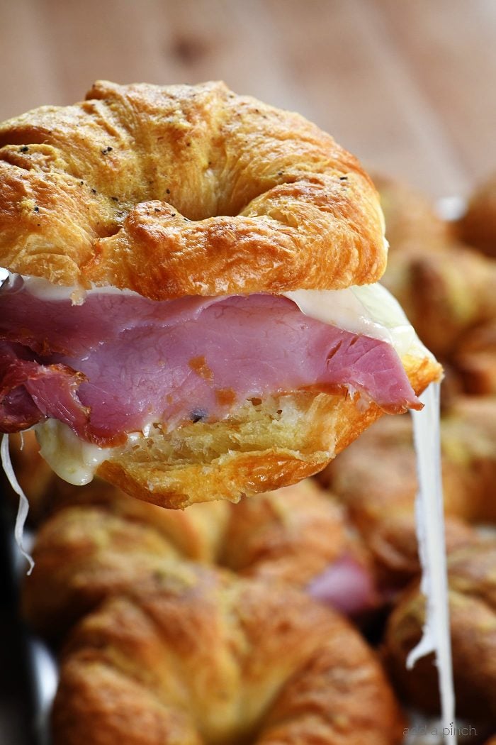 Ham and Cheese Croissants Recipe - These tasty, buttery, cheesy croissants are so simple to make and even more delicious to eat! Perfect for parties, entertaining, football games, and the holidays! // addapinch.com