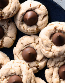 Peanut Butter Blossoms Recipe - This soft classic peanut butter cookie topped with a milk chocolate kiss is always a favorite! // addapinch.com