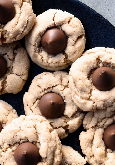 Peanut Butter Blossoms Recipe - This soft classic peanut butter cookie topped with a milk chocolate kiss is always a favorite! // addapinch.com