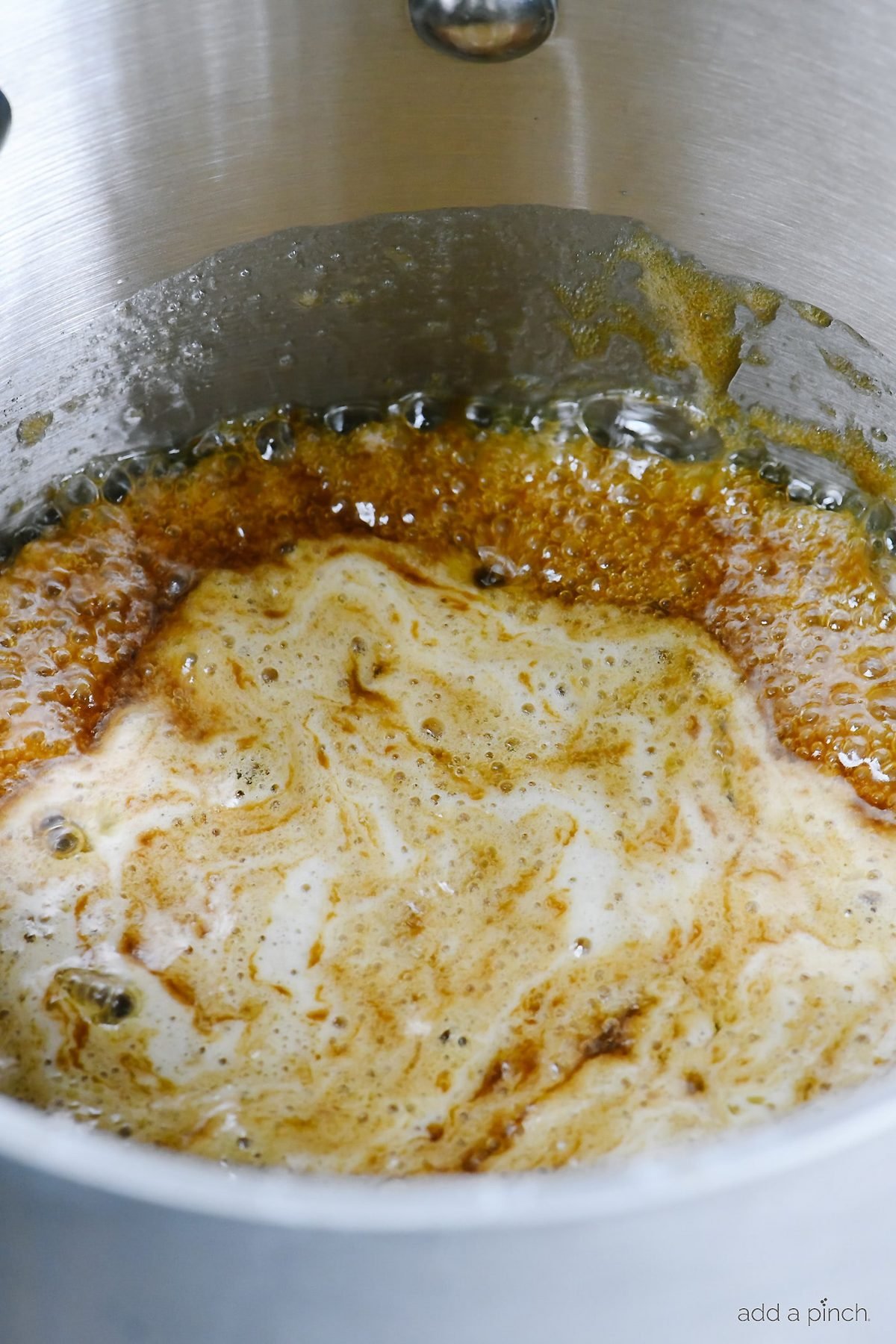 Stockpot has boiling brown sugar and butter to make a caramel. 