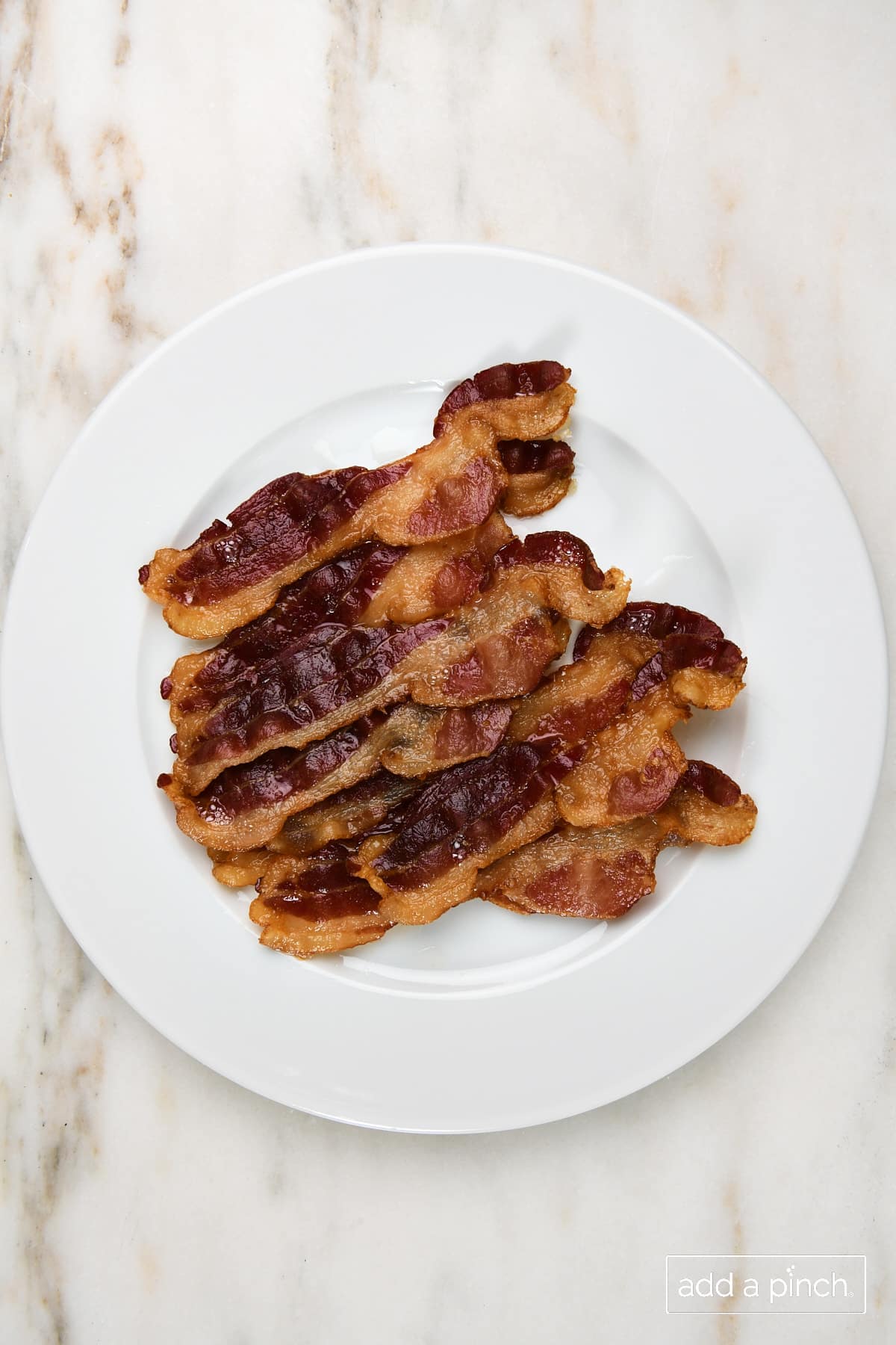 Bacon on a white plate.