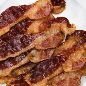 Photo of bacon on a white plate.