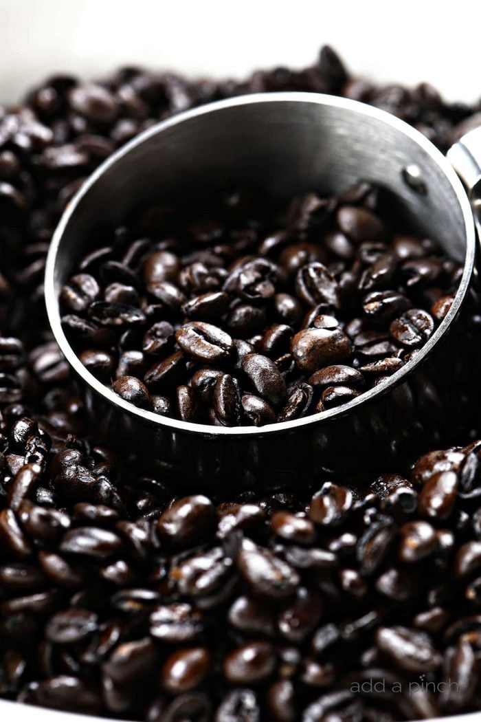 Espresso beans measured into a measuring cup.