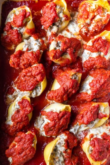 Photo of stuffed shells in a baking dish ready to be served.