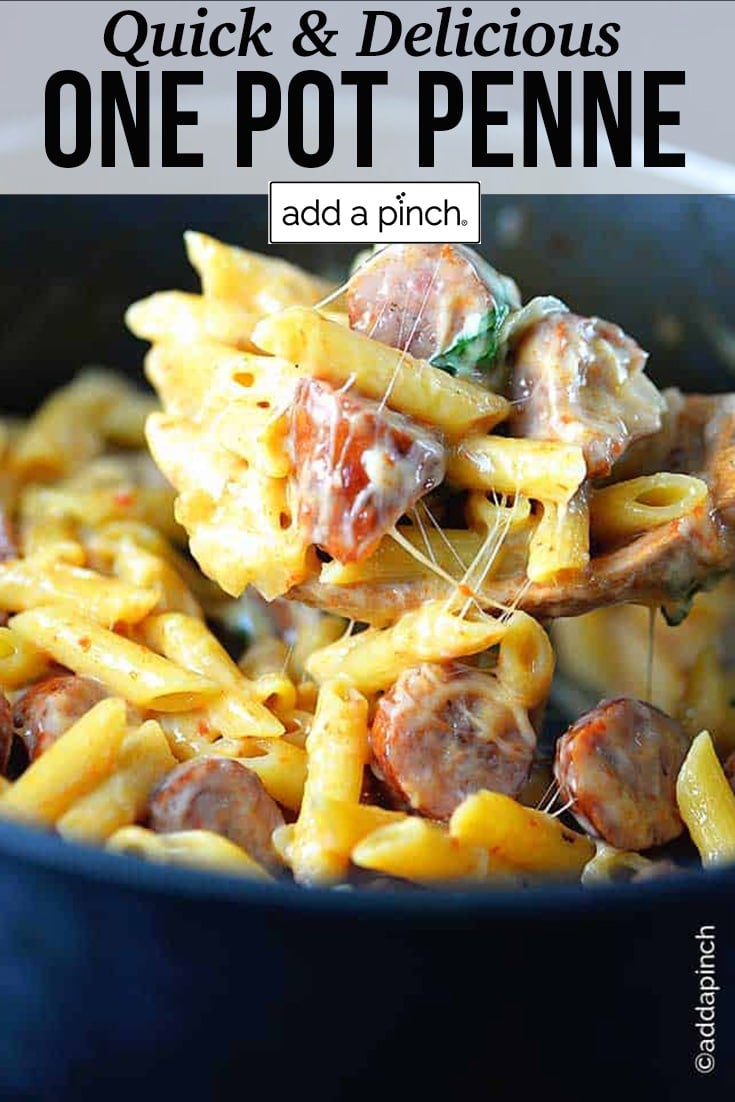 Bowl rounded over with penne pasta, cheese, sausage, spinach and peppers - with text - addapinch.com