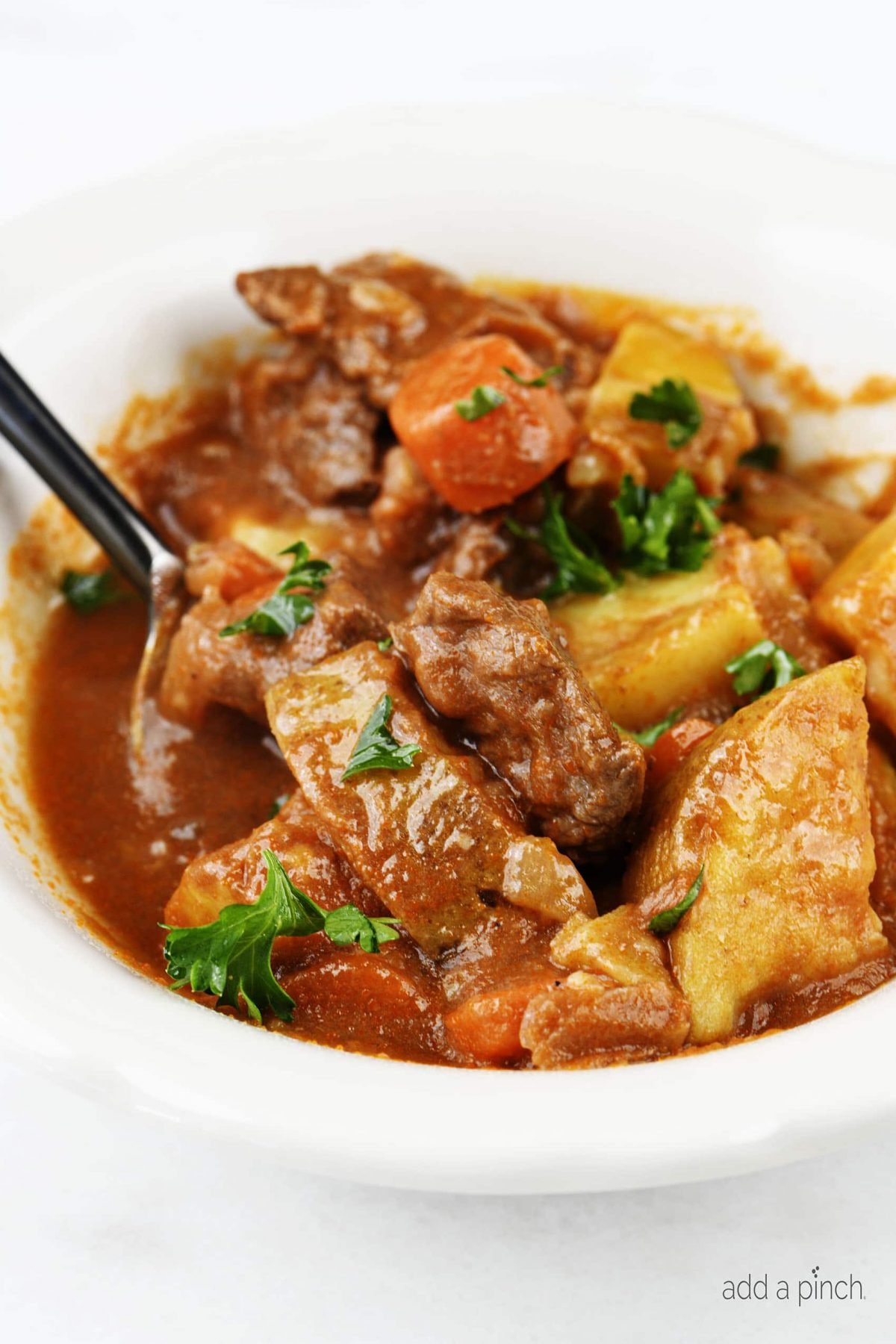 The Best Instant Pot Beef Stew Recipe - Mouthwatering beef stew made with tender chunks of beef, delicious vegetables and a hearty broth makes a favorite Instant Pot recipe! // addapinch.com