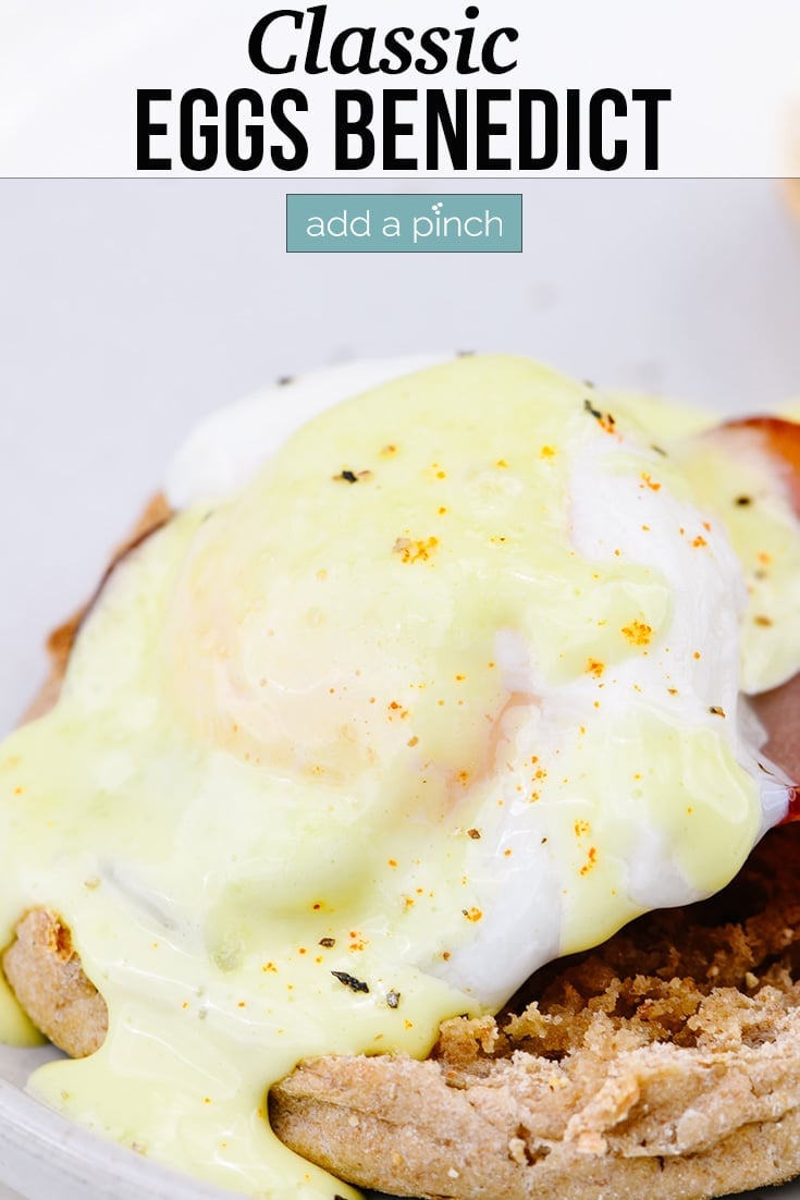 Eggs Benedict topped with hollandaise sauce - with text - addapinch.com