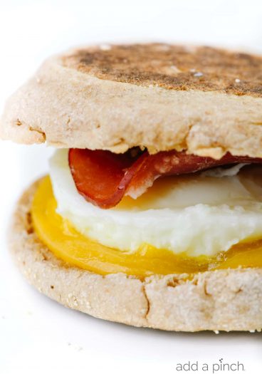Homemade Egg McMuffin Recipe - Turn the fast-food favorite into an easy homemade recipe everyone will love! Made with buttery English muffins, Canadian bacon, eggs, and cheese! // addapinch.com