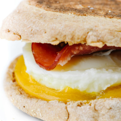 Homemade Egg McMuffin in closeup shot - with English muffin, cheese, egg, and Canadian bacon // addapinch.com
