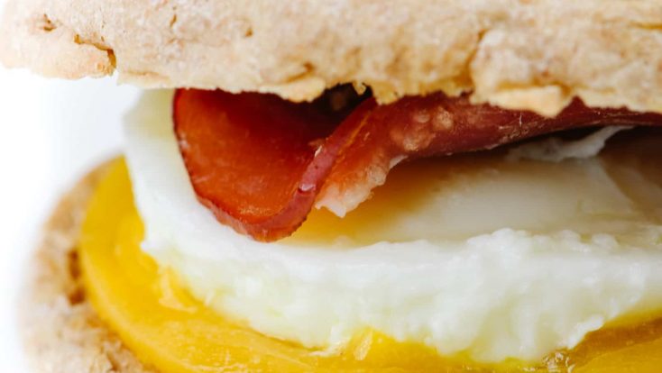 Homemade Egg McMuffin Recipe - Turn the fast-food favorite into an easy homemade recipe everyone will love! Made with buttery English muffins, Canadian bacon, eggs, and cheese! // addapinch.com