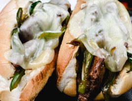 Philly Cheesesteak Recipe - Philly Cheesesteak Recipe - A Classic cheesesteak recipe made of seasoned, thinly sliced beef, peppers, onions, and lots of cheese! Ready in 30 minutes! // addapinch.com