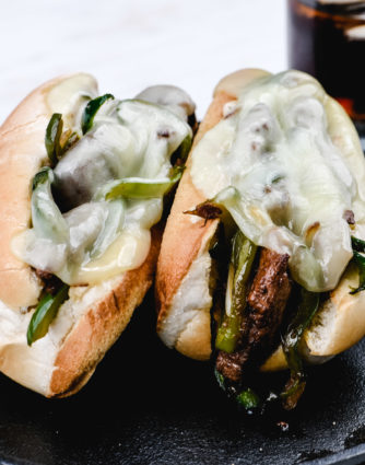 Philly Cheesesteak Recipe - Philly Cheesesteak Recipe - A Classic cheesesteak recipe made of seasoned, thinly sliced beef, peppers, onions, and lots of cheese! Ready in 30 minutes! // addapinch.com