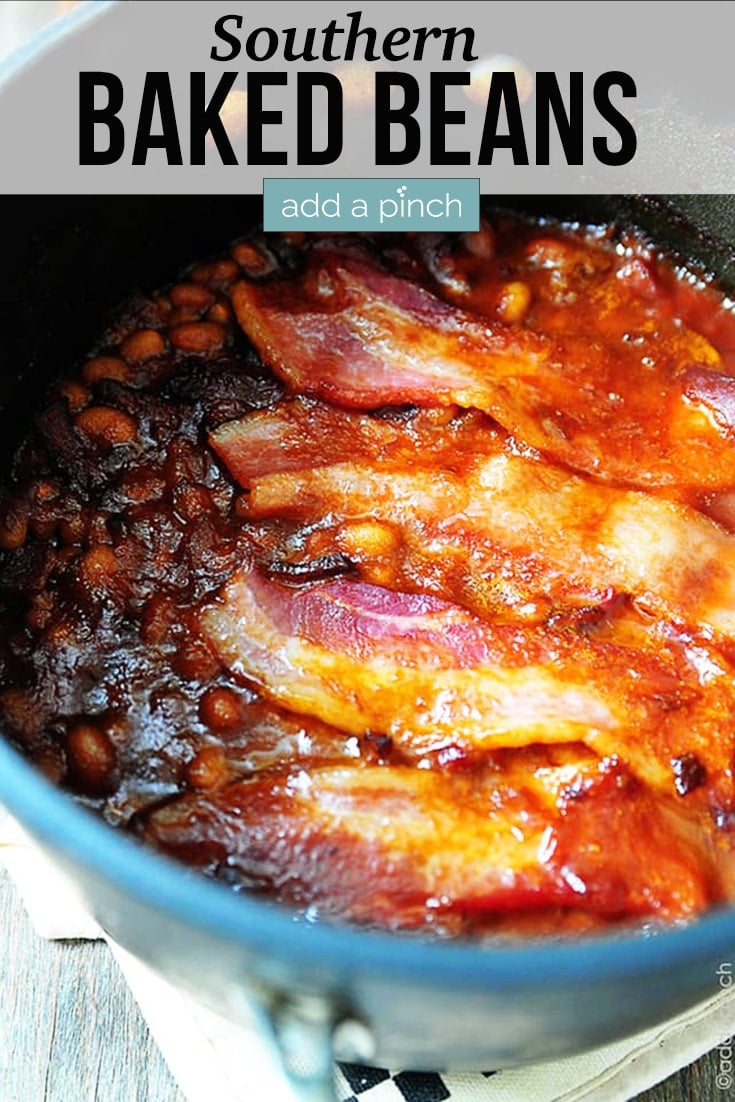 Southern Baked Beans covered in bacon in stockpot - with text - addapinch.com