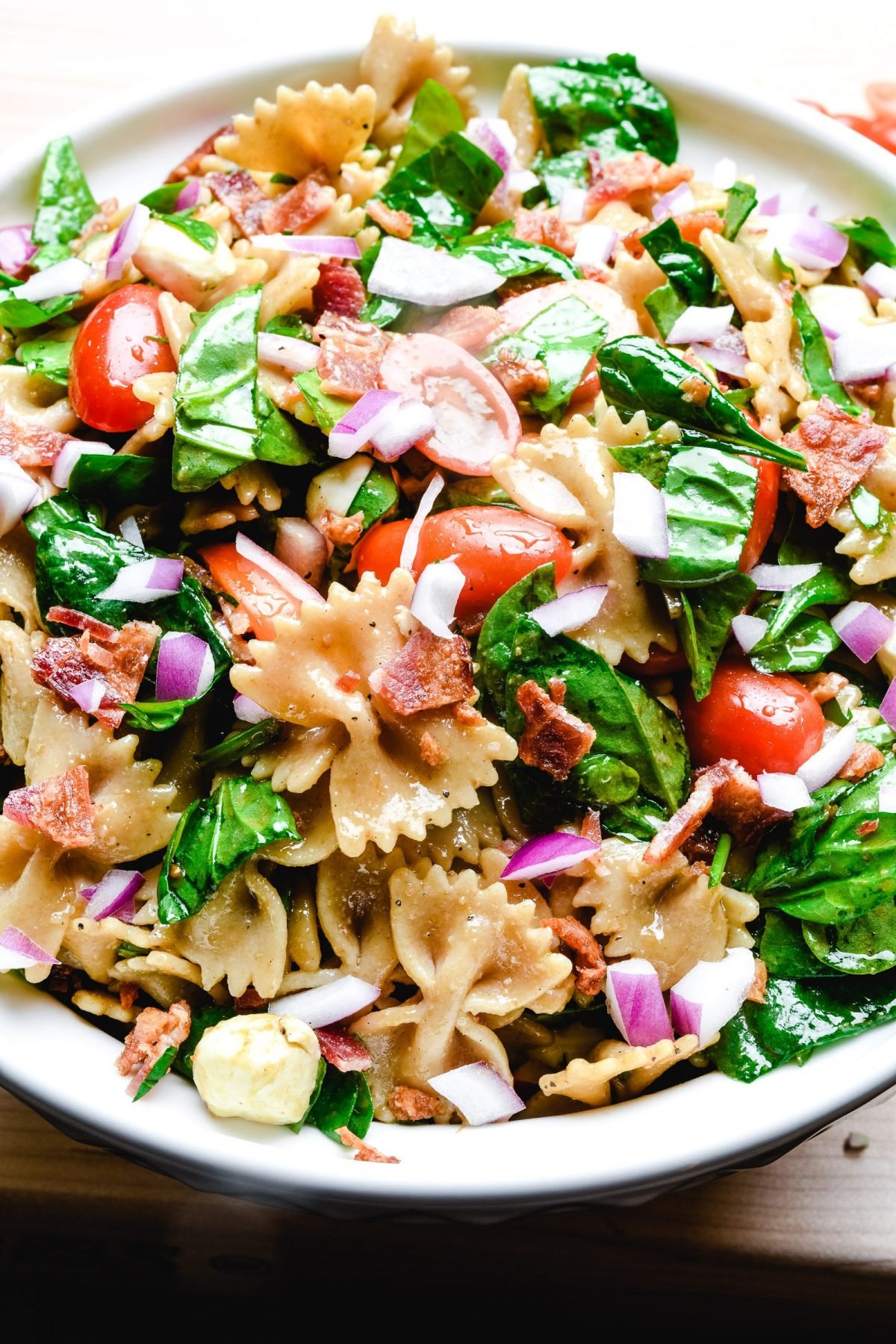 BLT pasta salad in white bowl.