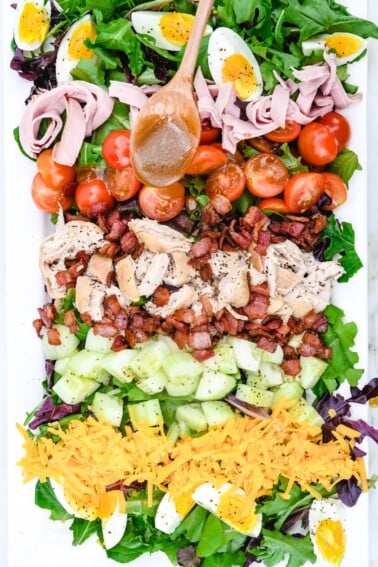 This Easy Chicken Club Salad Recipe is a delicious twist on the favorite layered club sandwich. Made of tender chicken, bacon, tomatoes, and so much more! It is always a favorite!