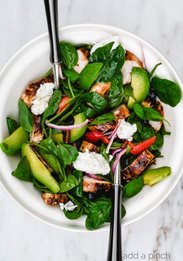 Grilled Chicken Salad with Strawberries and Avocado Recipe - This simple grilled chicken salad is made with fresh spinach, sweet berries and creamy avocado, then tossed with a quick balsamic dressing. Ready in 30 minutes! // addapinch.com
