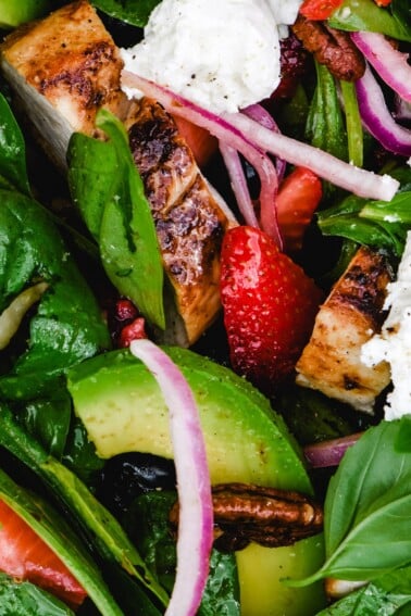 Grilled Chicken Salad with Strawberries and Avocado Recipe - This simple grilled chicken salad is made with fresh spinach, sweet berries and creamy avocado, then tossed with a quick balsamic dressing. Ready in 30 minutes!